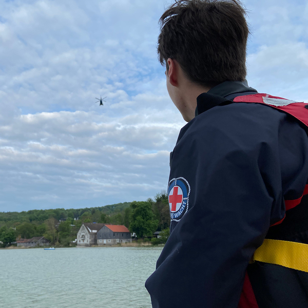Wasserretter mit Hubschrauber im Hintergrund